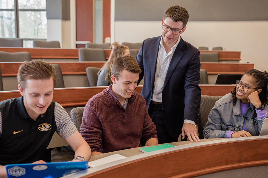 students interacting with professor in lecture hall
