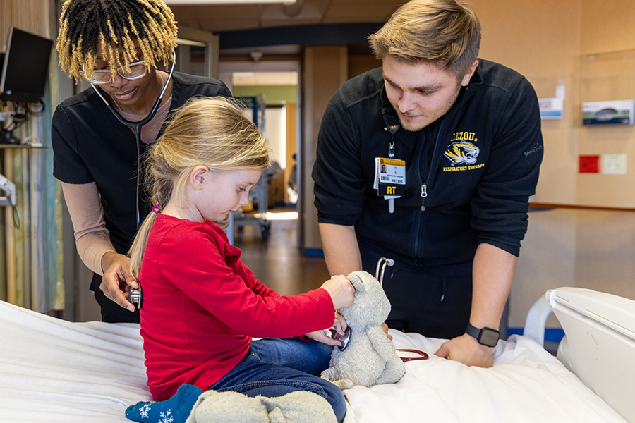 child patient being examined by medical professionals